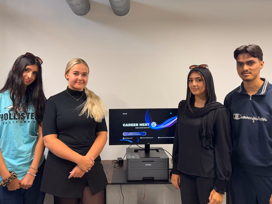 A team of sixth formers beside the screen showing the careers product they built.
