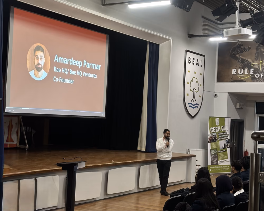 A Youth Startups speaker on stage at a partner school.